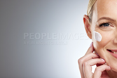 Buy stock photo Half face, skincare and cream on woman in studio on gray background mock up space. Beauty portrait, cosmetics and mature female model with facial creme, moisturizing lotion or product for anti aging.