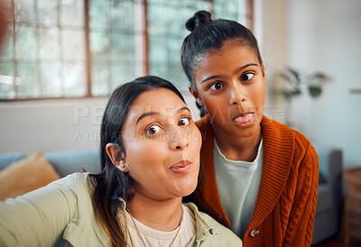 Buy stock photo Selfie, mother and daughter with funny, comic face and bonding in home lounge with love, care or together. Mom, girl child and digital picture for happiness, crazy time or social media in living room