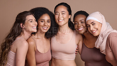 Buy stock photo Face portrait, beauty and diversity of women in studio isolated on a brown background. Makeup, cosmetics and group of different female models posing together for self love, inclusion and empowerment.