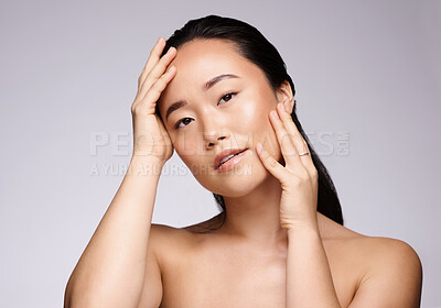 Buy stock photo Asian woman, portrait and beauty on studio background for skincare, makeup or cosmetics in Japan. Model touching face, wellness and natural glow of luxury salon facial, aesthetic health and self care