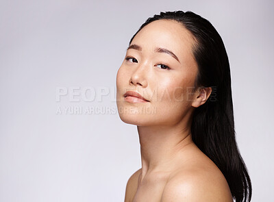 Buy stock photo Skincare, dermatology and woman with beauty, cosmetic marketing and smile for body glow on a studio background with mockup space. Makeup, wellness and portrait of an Asian model advertising cosmetics