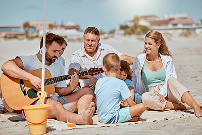 Buy stock photo Guitar, beach picnic and family on holiday, ocean bonding and musical entertainment in Portugal. Happy, travel and man playing instrument music on vacation, quality time and children with mom
