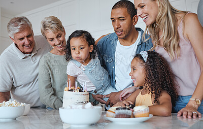 Buy stock photo Big family, birthday cake and blowing candles for a wish at home with parents, grandparents and children together for a celebration. Men, women and kids in UK house to celebrate at party for a girl 