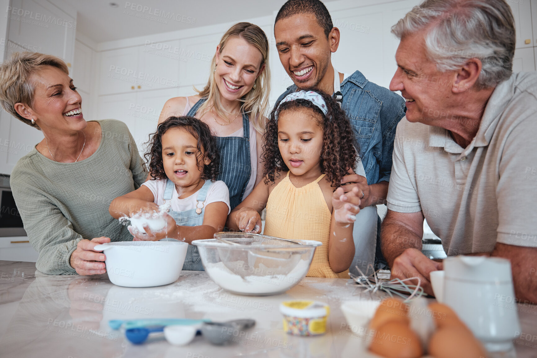 Buy stock photo Baking, family and children with their parents and grandparents in the kitchen learning about cooking food. Bake, bonding and love with girl siblings making baked goods in their home together