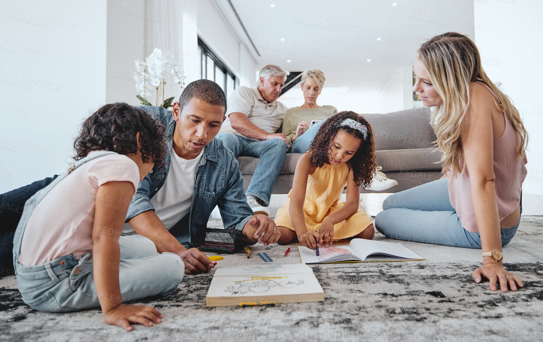 Buy stock photo Big family, kids and learning with father in living room, drawing in books and bonding. Education, care and love of parents, man and mother teaching girls art together with grandparents on home sofa.