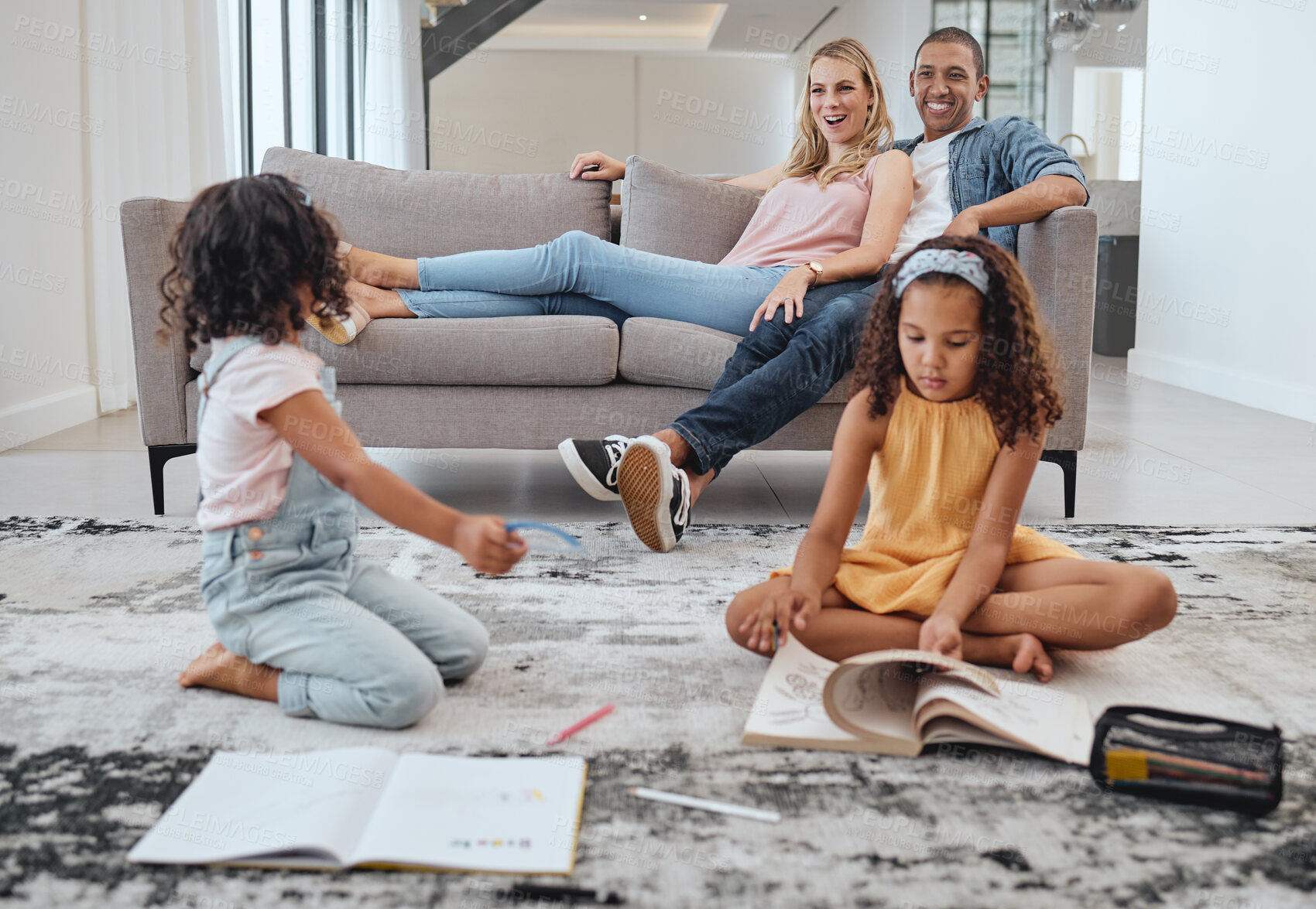 Buy stock photo Learning, education and kids with family in living room studying. Home school, diversity and girls reading books, writing or drawing with mother and father on sofa supporting development in house.