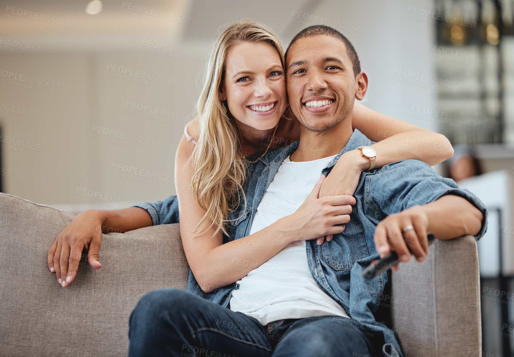 Buy stock photo Portrait of happy couple, diversity and hug in living room, lounge and apartment for love, care and support together. Happy woman embrace man for trust, happiness and loving relationship or marriage