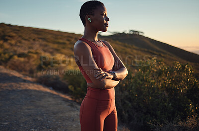 Buy stock photo Thinking, vision and fitness with a sports black woman standing arms crossed outdoor in nature. Exercise, training and workout with a female athlete listening to music during cardio or endurance