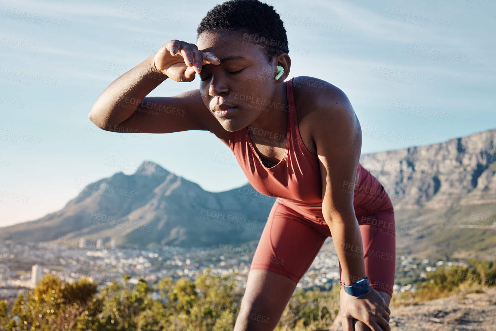 Buy stock photo Tired, music and mountain with black woman running in nature for sweat, endurance and breathing. Podcast, streaming and mobile radio with runner listening to earphones while training, cardio and goal