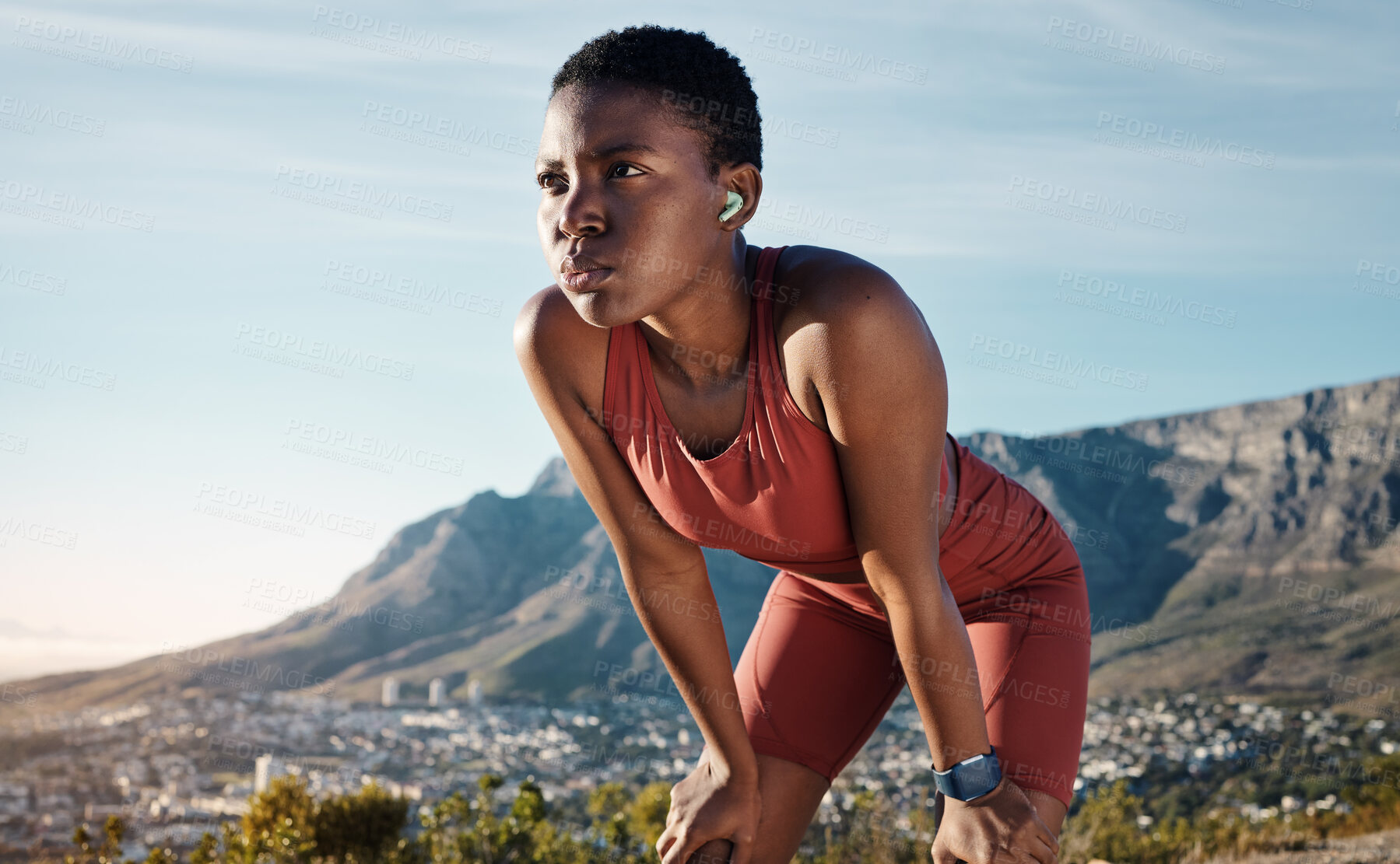 Buy stock photo Tired, music and mountain with black woman running in nature for sport, endurance and breathing. Podcast, streaming and mobile radio with runner listening to earphones while training, cardio and goal