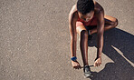 Black woman, fitness and shoes in preparation for running, exercise or cardio workout on mockup. African American woman runner tying shoe lace getting ready for race, run or sports above on mock up
