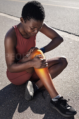 Buy stock photo Fitness, injury and pain with a sports black woman holding her knee during an exercise workout on an asphalt road. Running, marathon and anatomy with an injured female runner or athlete on a run