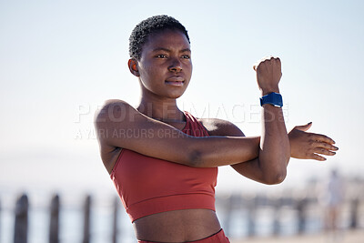 Buy stock photo Fitness, exercise and black woman stretching in city for healthy lifestyle, wellness and cardio workout. Sports, motivation and female athlete ready to start running, marathon training and jog by sea