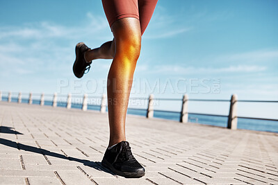 Buy stock photo Black woman runner, knee pain and legs by promenade, street or training by ocean in fitness, speed or health. Feet, sneakers and running on road by sea for wellness, nature workout or summer exercise
