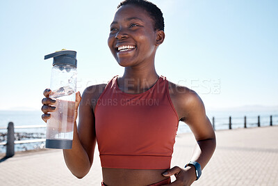 Buy stock photo Drinking water, fitness and black woman running by the sea for sport, training and exercise workout. Relax, freedom and sports smile of a runner athlete happy about cardio, energy and health wellness