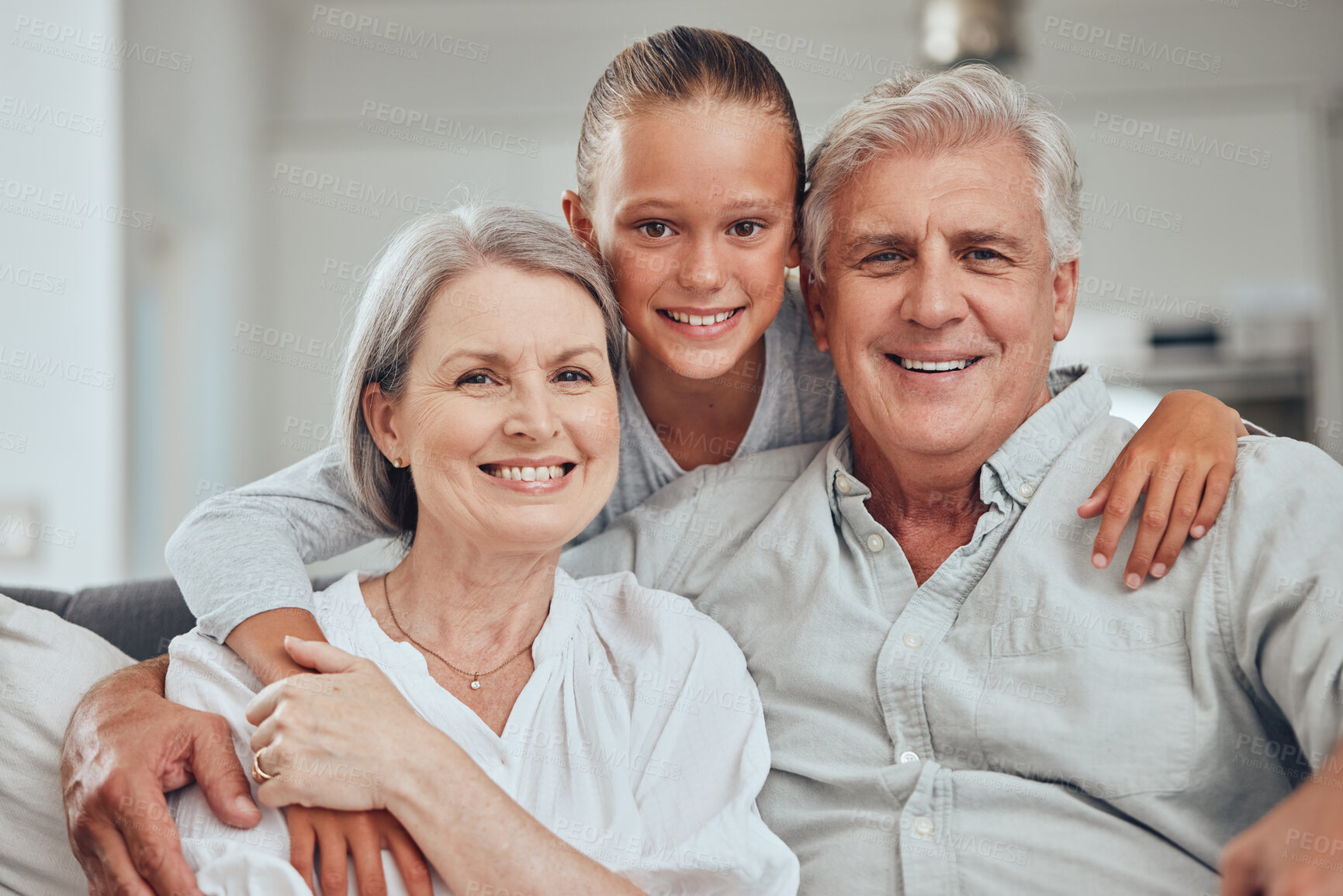 Buy stock photo Love, family and portrait by girl and grandparents on sofa for bond, hug and quality time in their home together. Happy family, face and senior man with woman relax with grandchild while babysitting