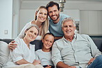 Portrait of grandparents, parents and child on sofa enjoying holiday, weekend and quality time together. Big family, love and senior couple bonding with mom, dad and girl on couch in family home