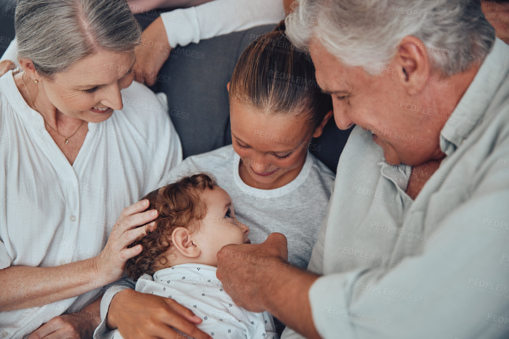 Buy stock photo Big family, baby and relax on sofa together in living room for love, support and children care. Grandparents, big sister and kid smile for happiness, quality time and bonding on couch in family home