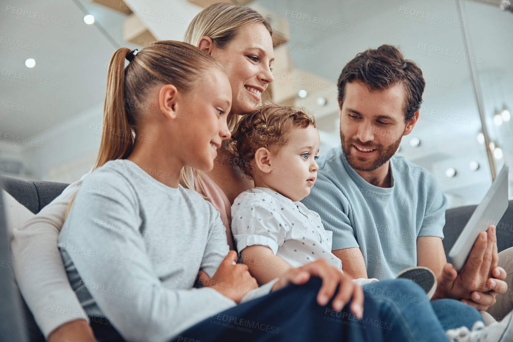 Buy stock photo Living room, tablet and happy family streaming a movie online while relaxing on a sofa together at home. Mother, father and children watching video on social media or the internet with mobile device.