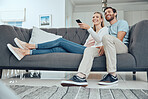 Couple, sofa and relax with tv remote, smile and happiness in home living room for bonding with love. Happy couple, couch and comedy on television, streaming or movie while laughing together in house