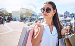 Shopping bags, retail and sunglasses with woman in city for fashion, sales and expensive boutique. Deal, products and discount with girl customer buying for spree, luxury and offer at store outlet