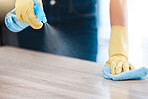 Cleaning, housekeeping and hands with spray bottle on furniture for spring cleaning, dust and dirt on surface. Housework, healthcare and person with rubber gloves, cleaning products and disinfection