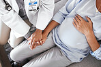 Healthcare, pregnancy and hands of doctor with pregnant woman for support, comfort and compassion on sofa. Medical care, family home and top view of health worker holding hands with maternal patient