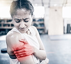 Woman, fitness and shoulder pain in gym for exercise workout, training accident and sports medical emergency. Sad athlete, arm injury and physical therapy, arthritis or muscle wellness in health club