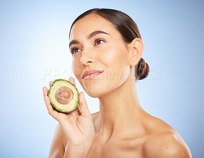 Buy stock photo Beauty, health and skincare with woman and avocado for facial, natural products and detox. Nutrition, spa and diet with face of girl model for self care, wellness and glow in blue background studio 