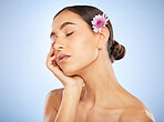 Face, beauty skincare and woman with flower in studio on blue background mockup. Floral cosmetics, organic makeup and female model with eyes closed, healthy or glowing skin after spa facial treatment