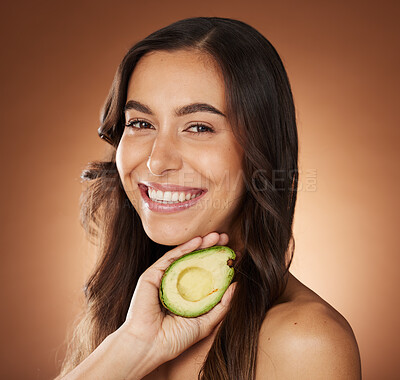 Buy stock photo Woman, face and smile portrait with avocado for skincare beauty, natural organic dermatology or cosmetics wellness in brown studio background. Model, detox happiness and luxury facial care nutrition 