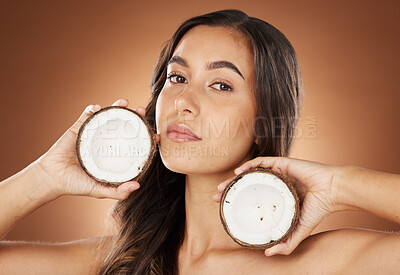 Buy stock photo Woman, coconut and beauty portrait for skincare wellness, natural cosmetics care and dermatology in brown background. Headshot, organic spa product or healthy coconut oil face detox results in studio