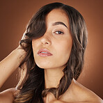 Woman, face skincare or curly hairstyle on brown studio background in color dye advertising, self love or Brazilian keratin treatment. Portrait, beauty model or brunette waves and natural makeup glow