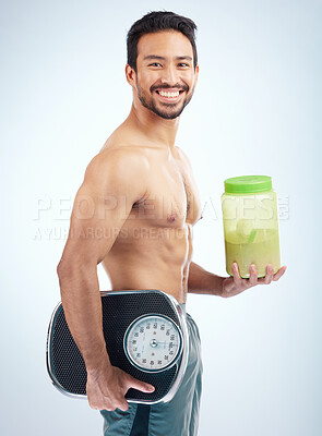 Buy stock photo Man, diet or body protein powder on blue studio background in weight loss, bodybuilding or Japanese muscle growth. Portrait, smile or happy athlete with weight scale or healthcare wellness supplement