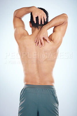 Buy stock photo Man, body or stretching back muscles on blue background in studio pain relief, healthcare wellness or burnout tension release. Sports athlete, fitness model or coach flexing in workout success check