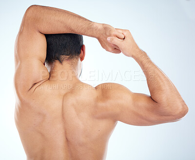 Buy stock photo Man, fitness stretching and back view for muscle wellness, body care and sports exercise or warm up in studio. Athlete, arm stretch and bodybuilder training, healthy performance or  spine workout