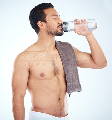 Buy stock photo Fitness, health or man drinking water in studio after training in workout or exercise for body goals or wellness. Motivation, weight loss or tired healthy person relaxing and drinks liquid or bottle