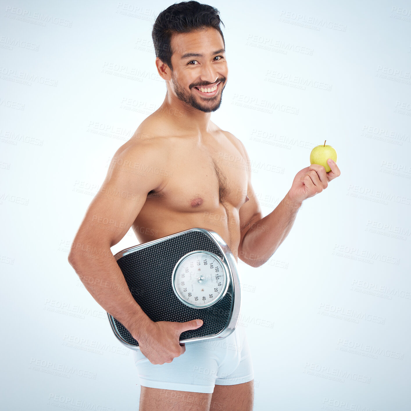 Buy stock photo Portrait, fitness and man with apple and scale in studio isolated on a blue mockup background. Weight loss, healthy diet and happy male model with fruit or food for nutrition, vitamin c and wellness.