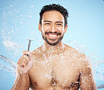 Face portrait, water splash and man with razor for shaving in studio on blue background. Skincare, shower or male model with blade for beard shave, grooming or hygiene, cleaning or bath for wellness.