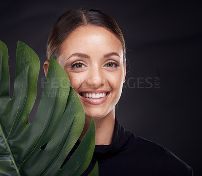 Buy stock photo Beauty, face and skin with leaf and woman with natural cosmetics, green and sustainable skincare against black studio background. Portrait, mockup and nature, tropical organic product and wellness.