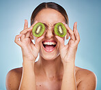 Beauty, kiwi and face, woman and skincare with natural glow from organic and vegan cosmetics for facial treatment Healthy skin, exotic fruit product and happy, wellness with blue studio background.