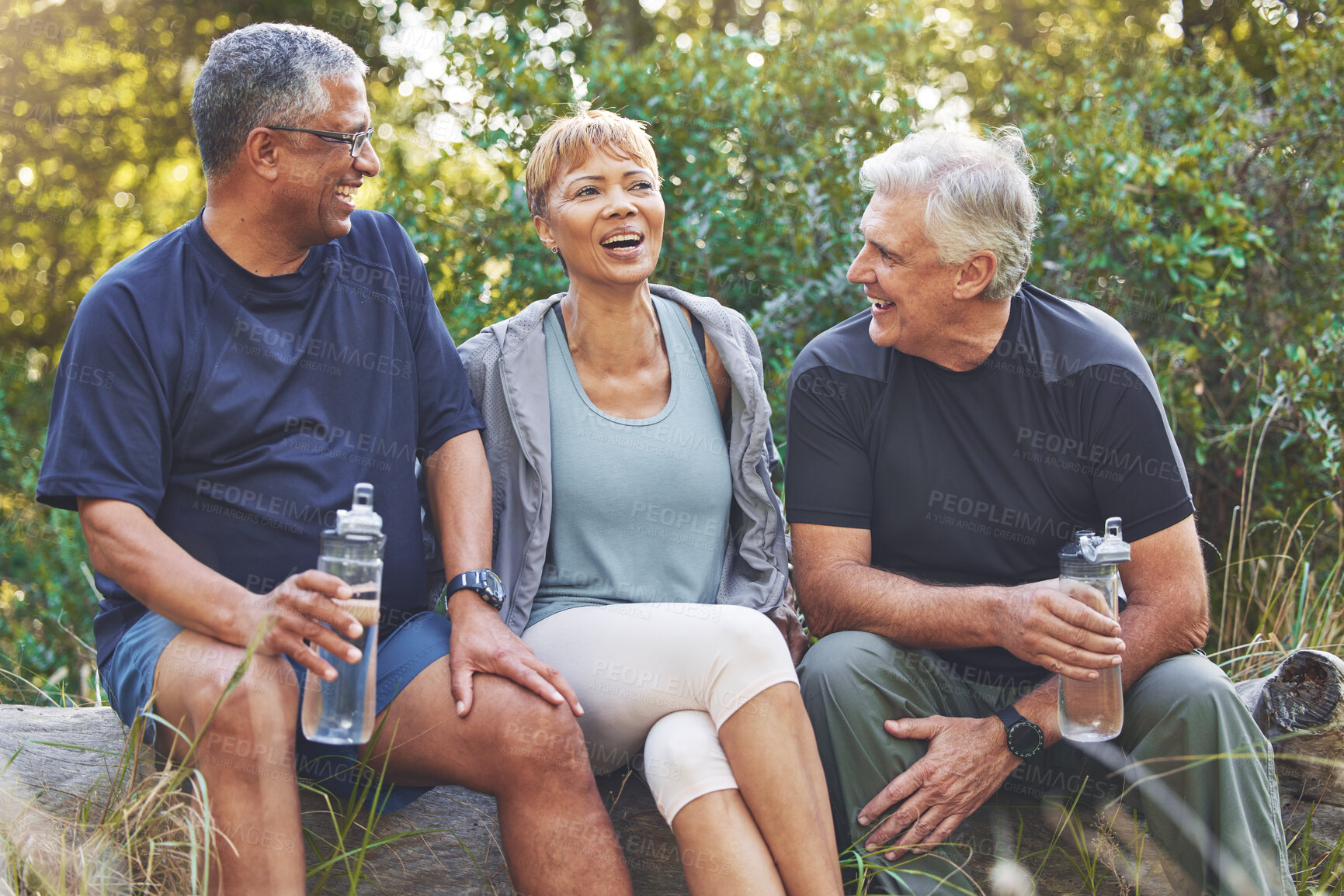 Buy stock photo Nature, fitness and senior friends in conversation while sitting in the forest after hiking. Happiness, communication and elderly people talking, bonding and drinking water after outdoor exercise.