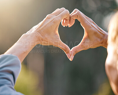 Buy stock photo Hands, heart and people with a love sign in nature while on adventure, vacation or trip together. Freedom, romance and hand romantic gesture with shape emoji in the park, forest or woods on holiday.