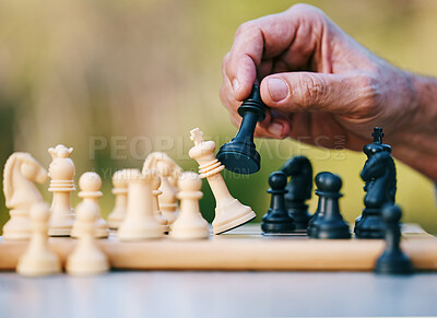 Buy stock photo Chess, play or hand with a king on a board game with a winning strategy in a tournament outdoors in nature. Checkmate, mindset or smart man playing in a sports contest or problem solving challenge 