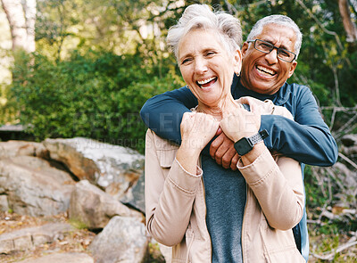 Buy stock photo Hiking, laugh and romance with a senior couple hugging while in the woods or nature forest together in summer for a hike. Fun, joke and bonding with a mature man and woman enjoying retirement outdoor