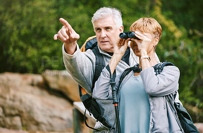 Buy stock photo Elderly, couple hiking and fitness, adventure outdoor with hike together, active lifestyle with freedom and travel. Nature, trekking and senior man pointing and woman with binocular for bird watching