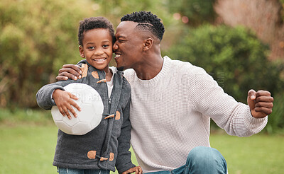 Buy stock photo Portrait of a little boy and his father playing with a soccer ball together outdoors