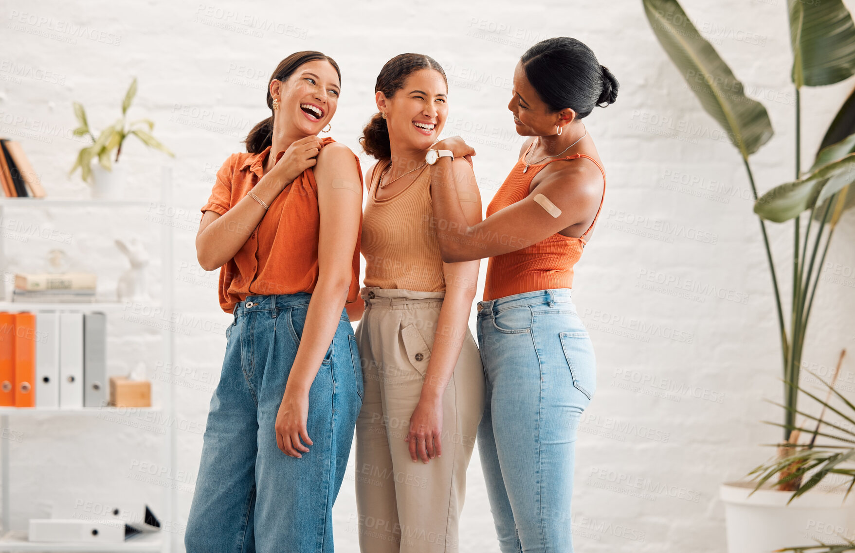Buy stock photo Female friends after receiving covid vaccine, happy and smiling, approving the immunity injection showing plaster arms. Diverse women recommend booster jab for protection from corona virus.