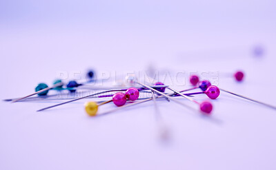 Buy stock photo Closeup, sewing pin and design in studio by purple background for clothing manufacturing in factory. Macro, metal needles or table for fashion, clothes or workshop for  tailor, designer or seamstress