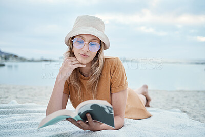 Buy stock photo Beach, relax and woman reading a book in peaceful summer holidays or vacation outdoors in nature with freedom. Travel, ocean and young girl enjoying quality time alone, break and calm resting trip 